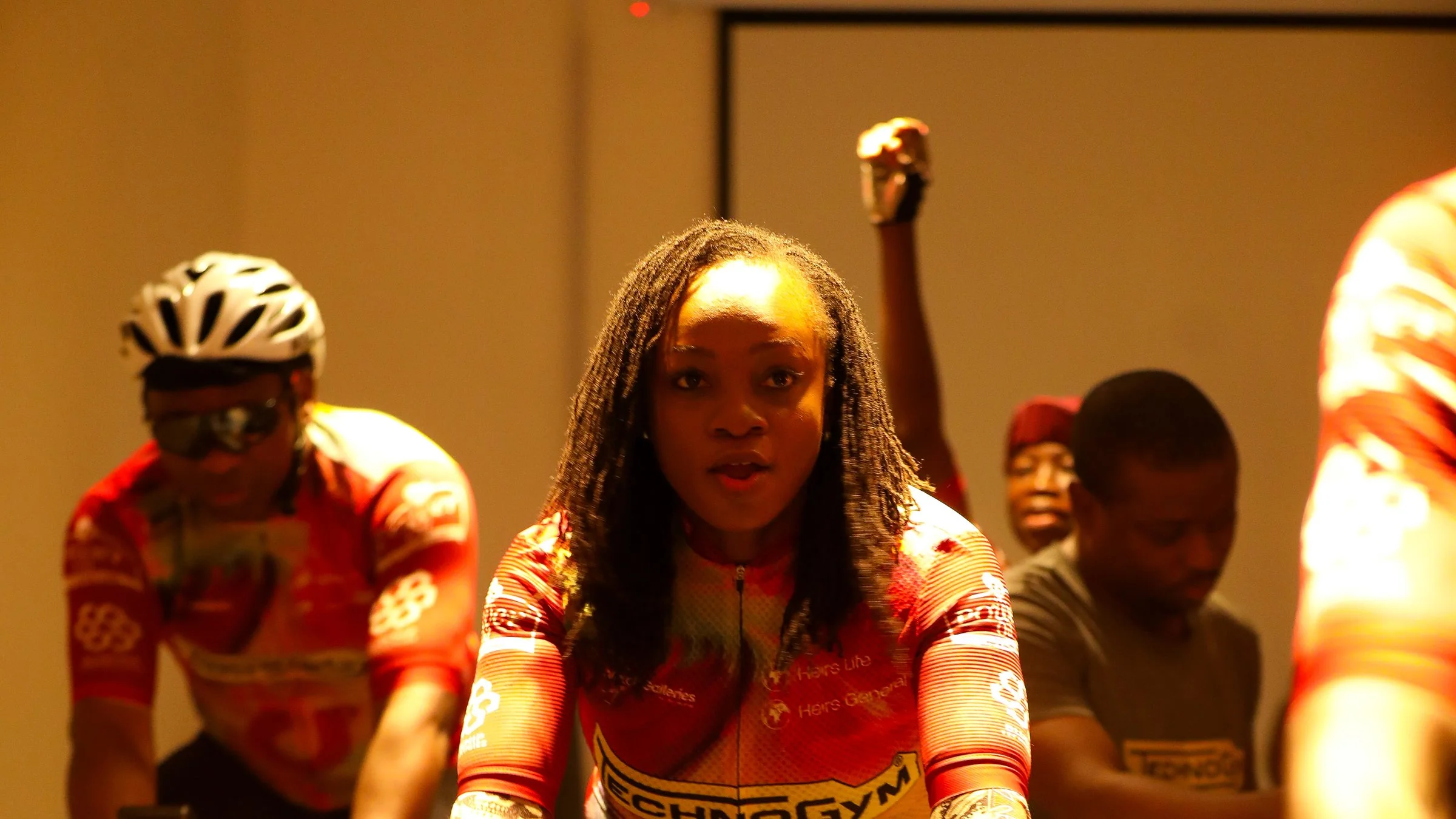 A rider training on a Technogym indoor bike during a group cycling session