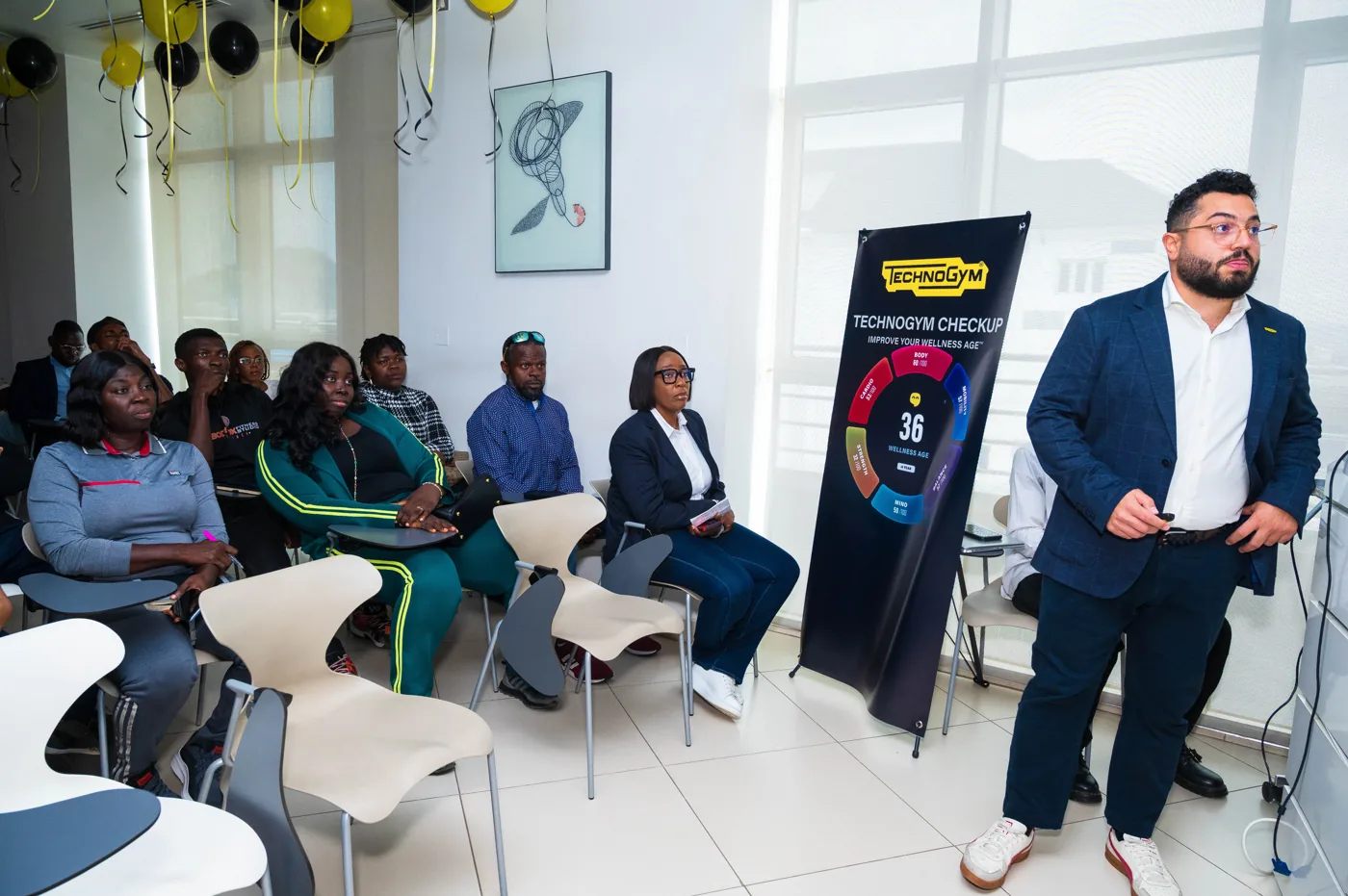 A Technogym Checkup wellness assessment presented to a seated group